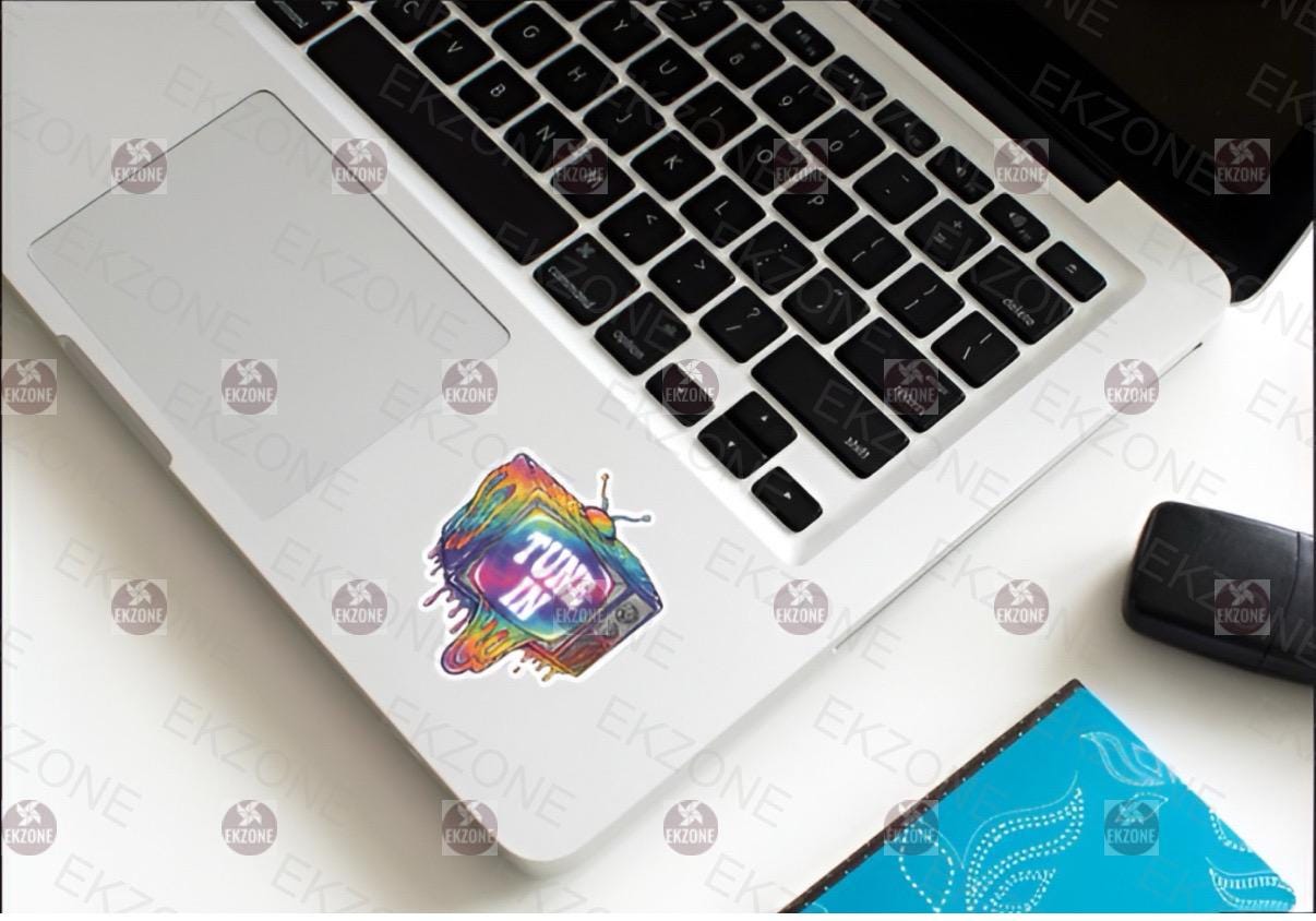 Laptop with a colorful sticker on a white surface
