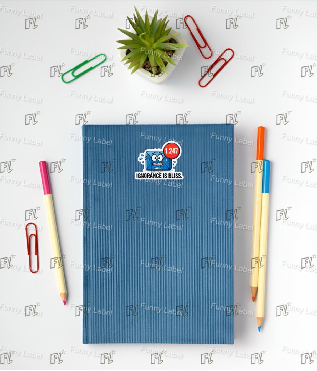 Blue notebook with a sticker, two pens, and paper clips on a white background