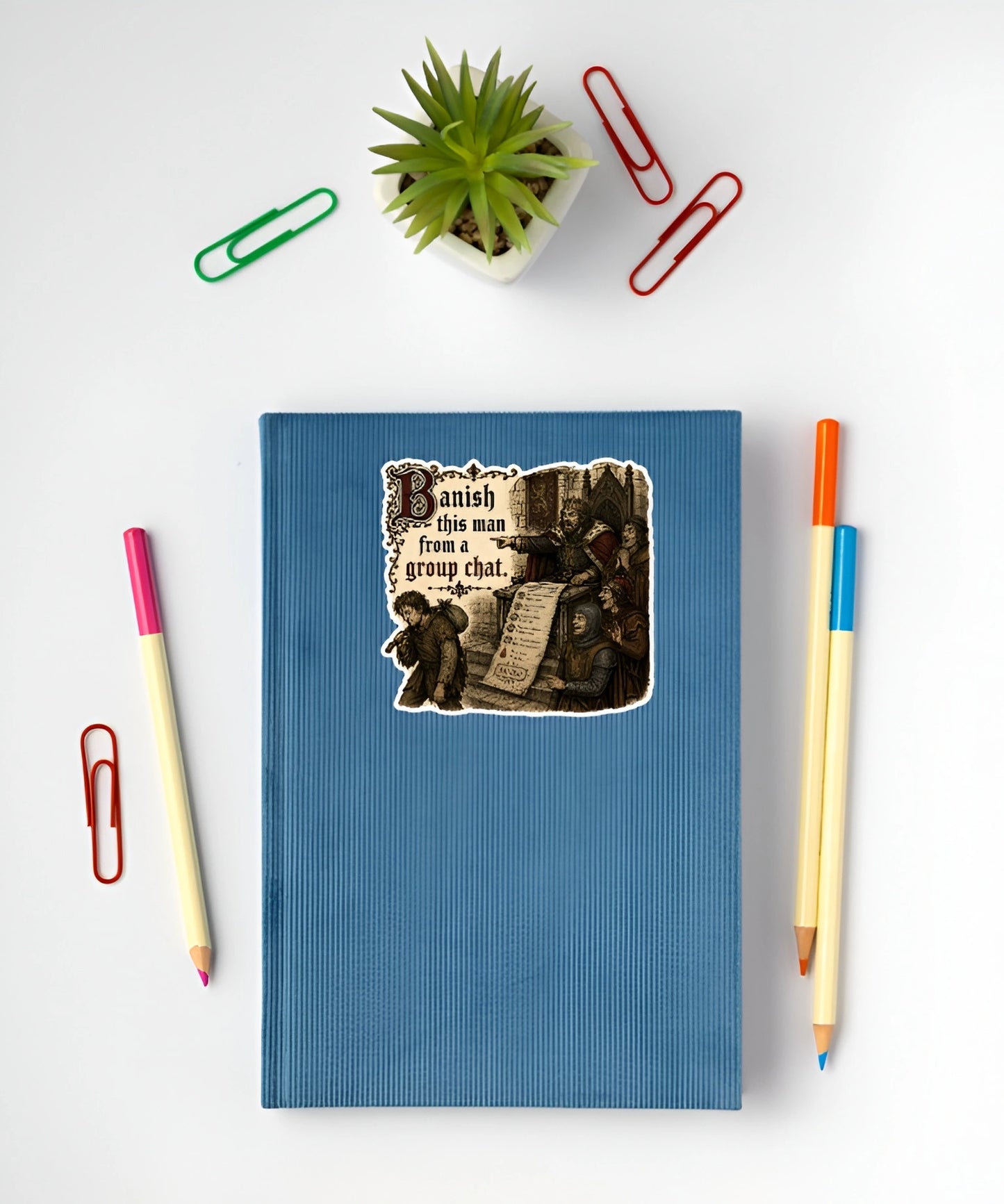 Banish This Man From a Group Chat sticker displayed on a blue notebook