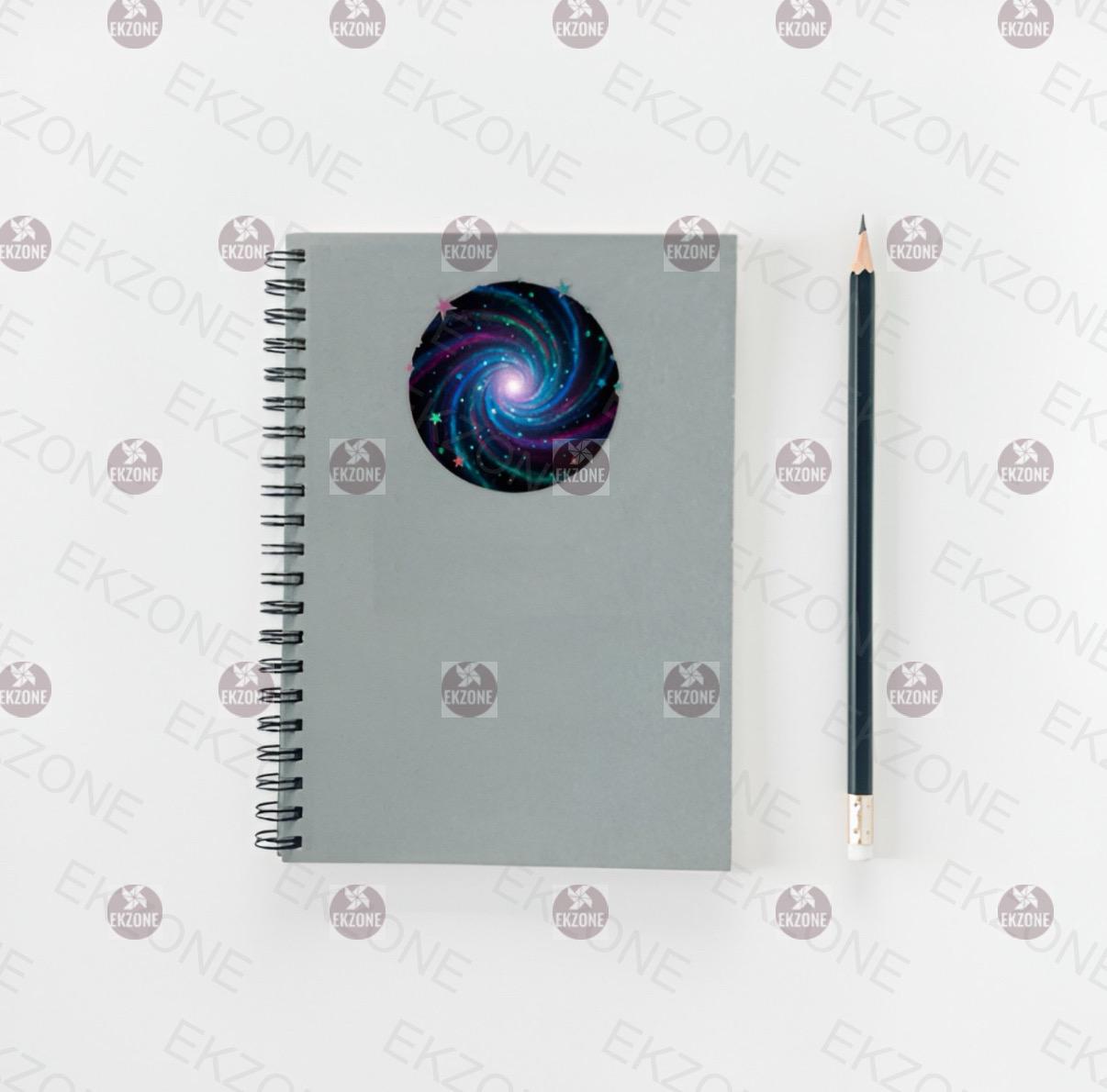 Notebook with galaxy design on cover and pencil on a white background