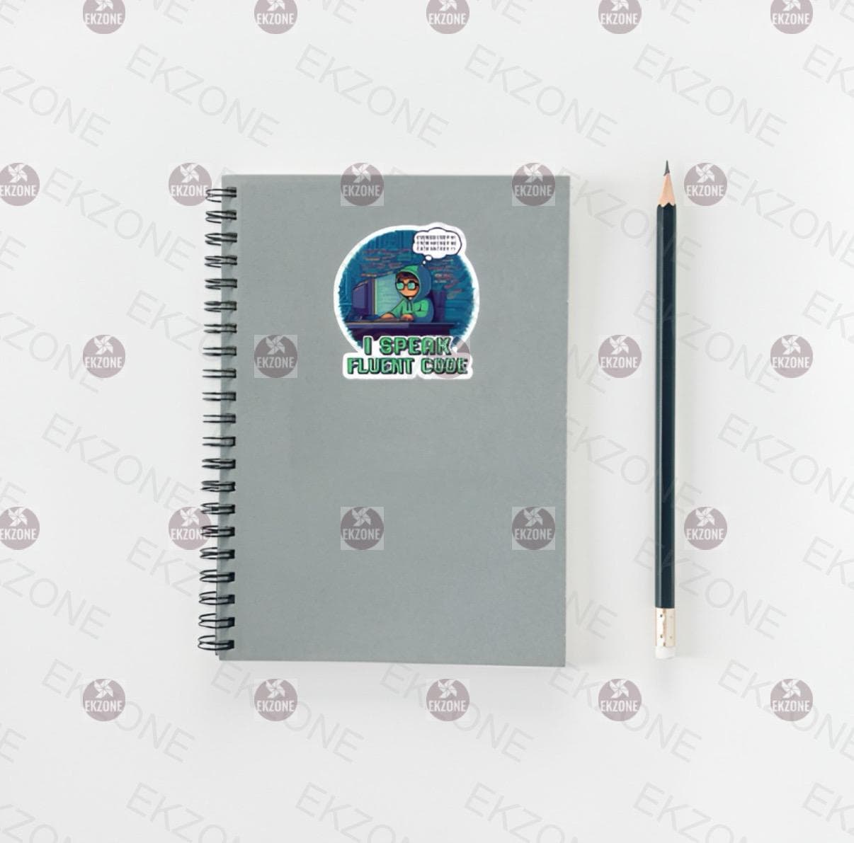 Gray spiral-bound notebook with a sticker and a pencil on a white background.