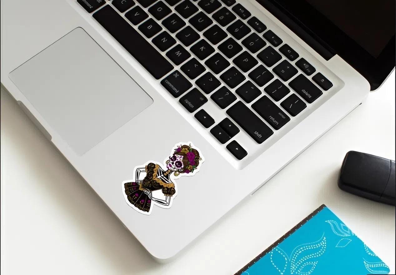 Laptop with decorative stickers on a desk