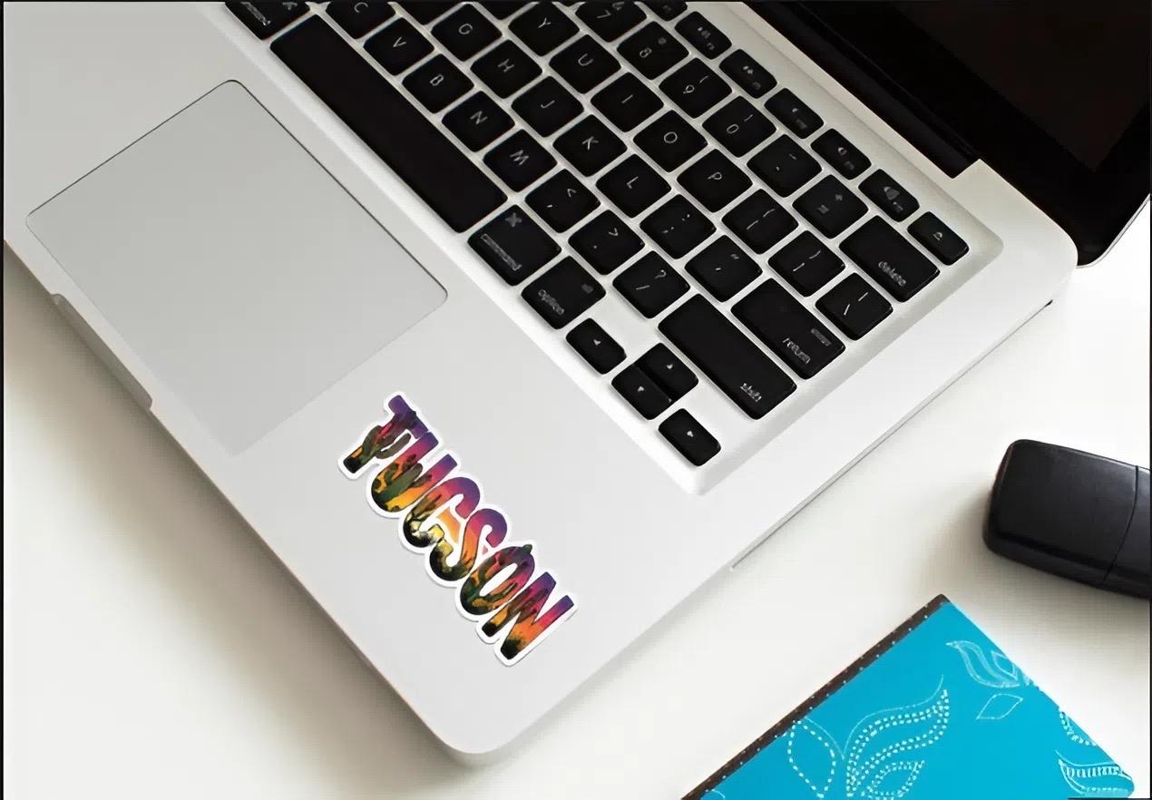 Laptop with a colorful 'Wilson' sticker on a desk