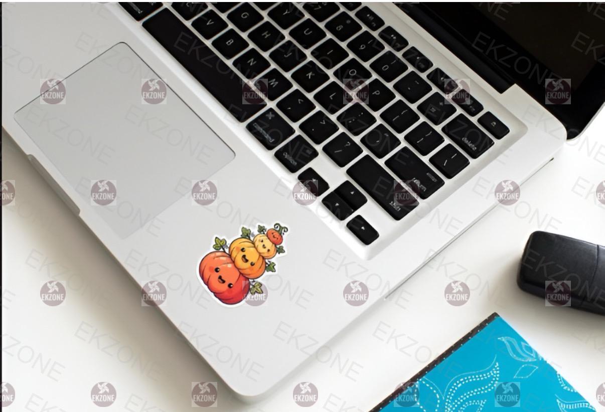 Laptop with a decorative sticker on the palm rest area, placed on a white surface.