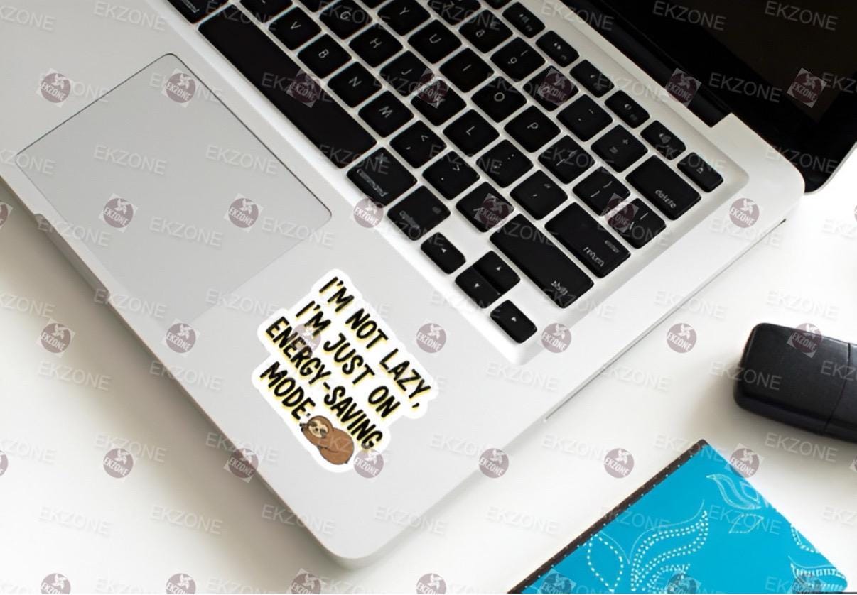 Laptop with a sticker on the keyboard area, placed on a white surface.