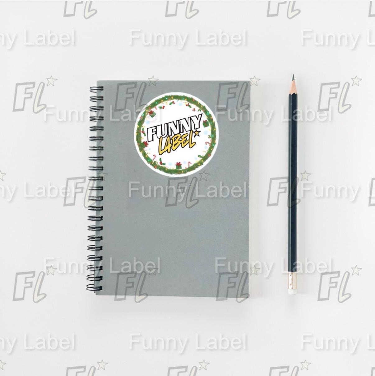 Gray notebook with a pencil on a white background featuring 'Funny Label' branding.