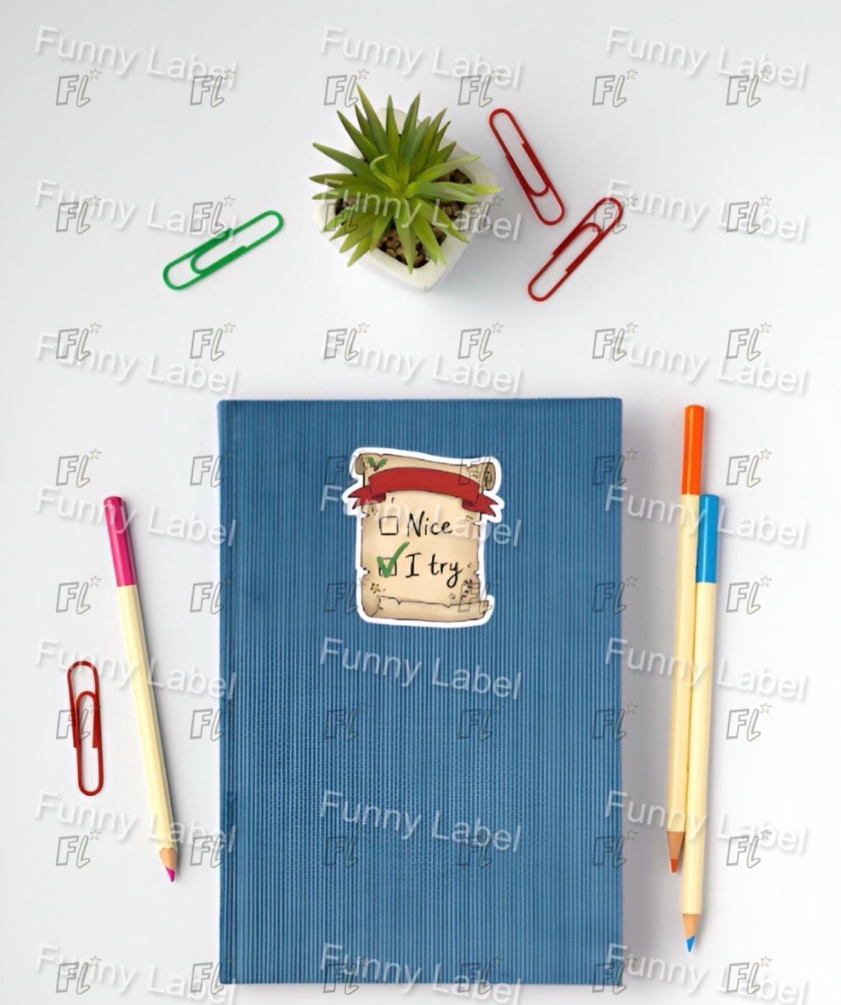 Blue notebook with decorative label, colored pencils, and paper clips on a white background