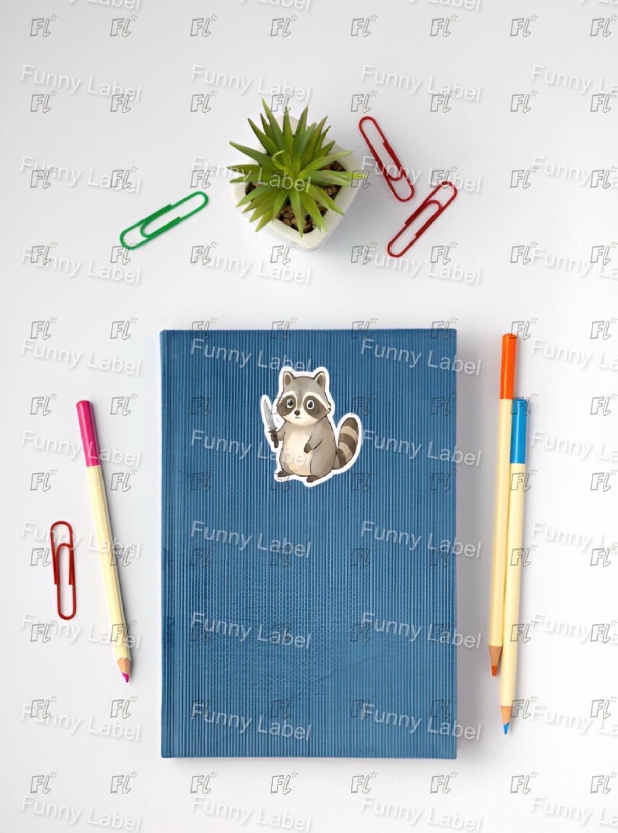 Blue notebook with a raccoon sticker on a white background with stationery items