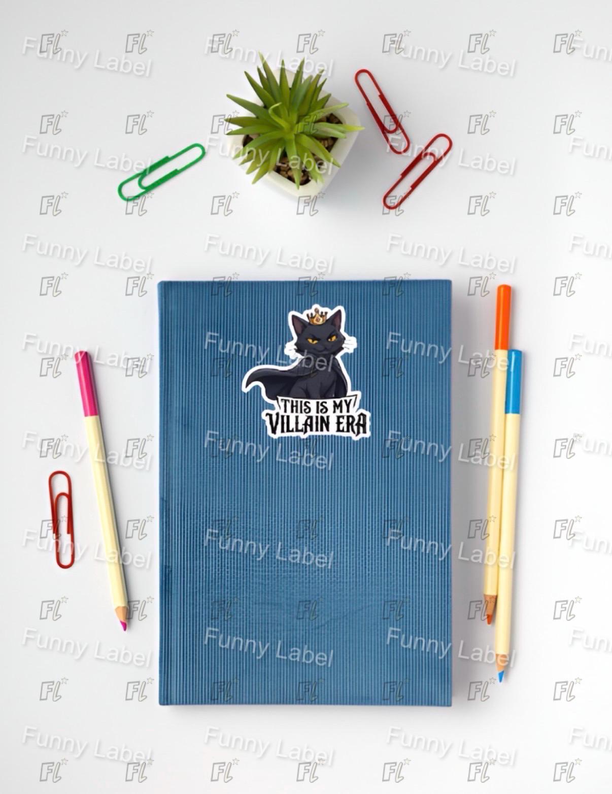 Blue notebook with a sticker on top, surrounded by office supplies on a white background.