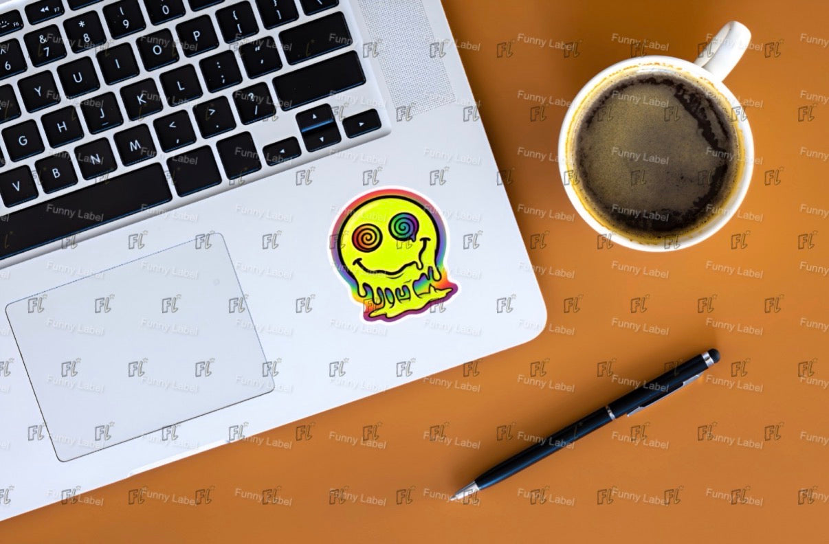 Laptop with a sticker, coffee cup, and pen on a brown surface