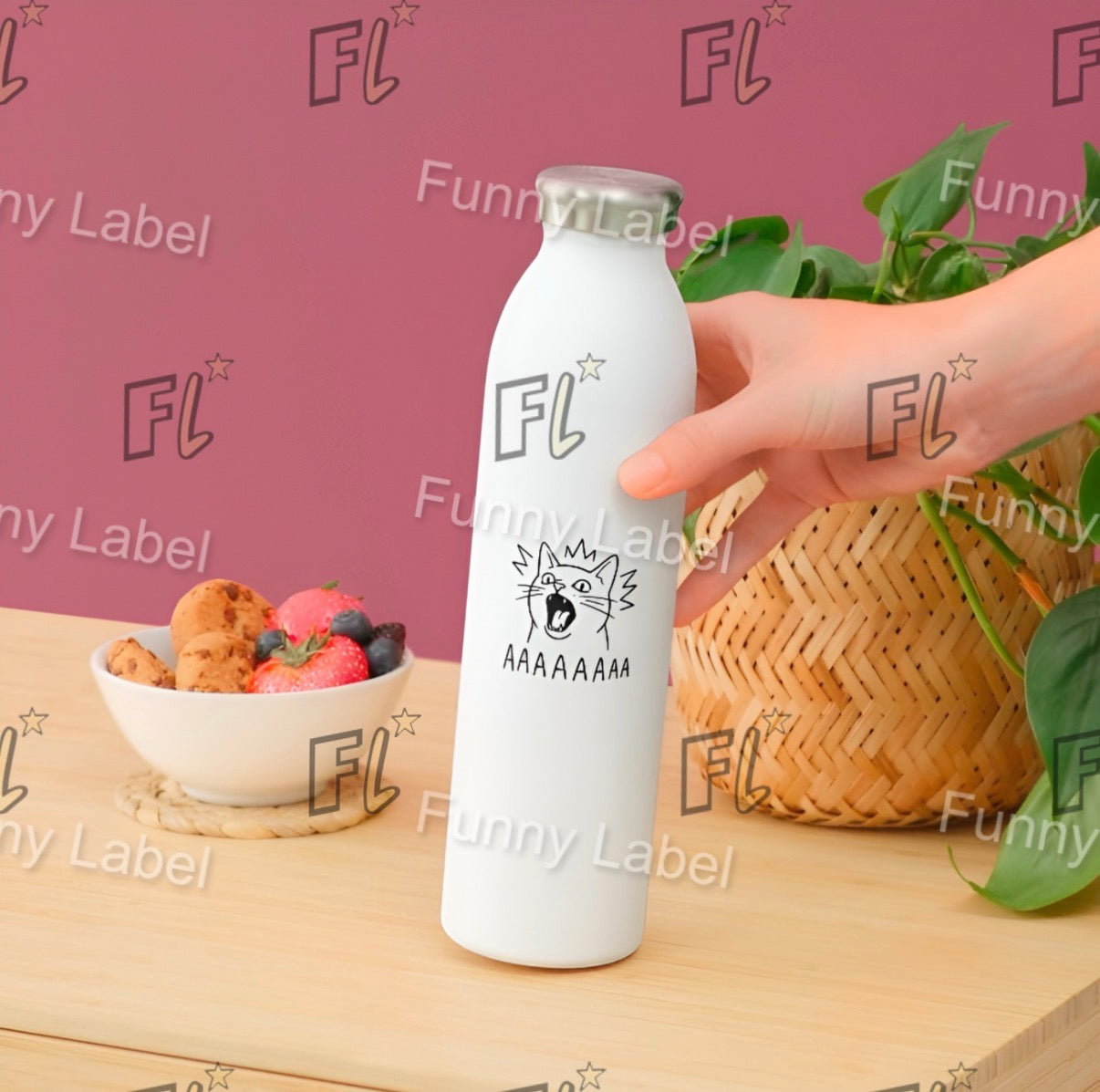 White bottle with 'FL' label held by a hand on a wooden surface with a bowl of fruit and a basket in the background.