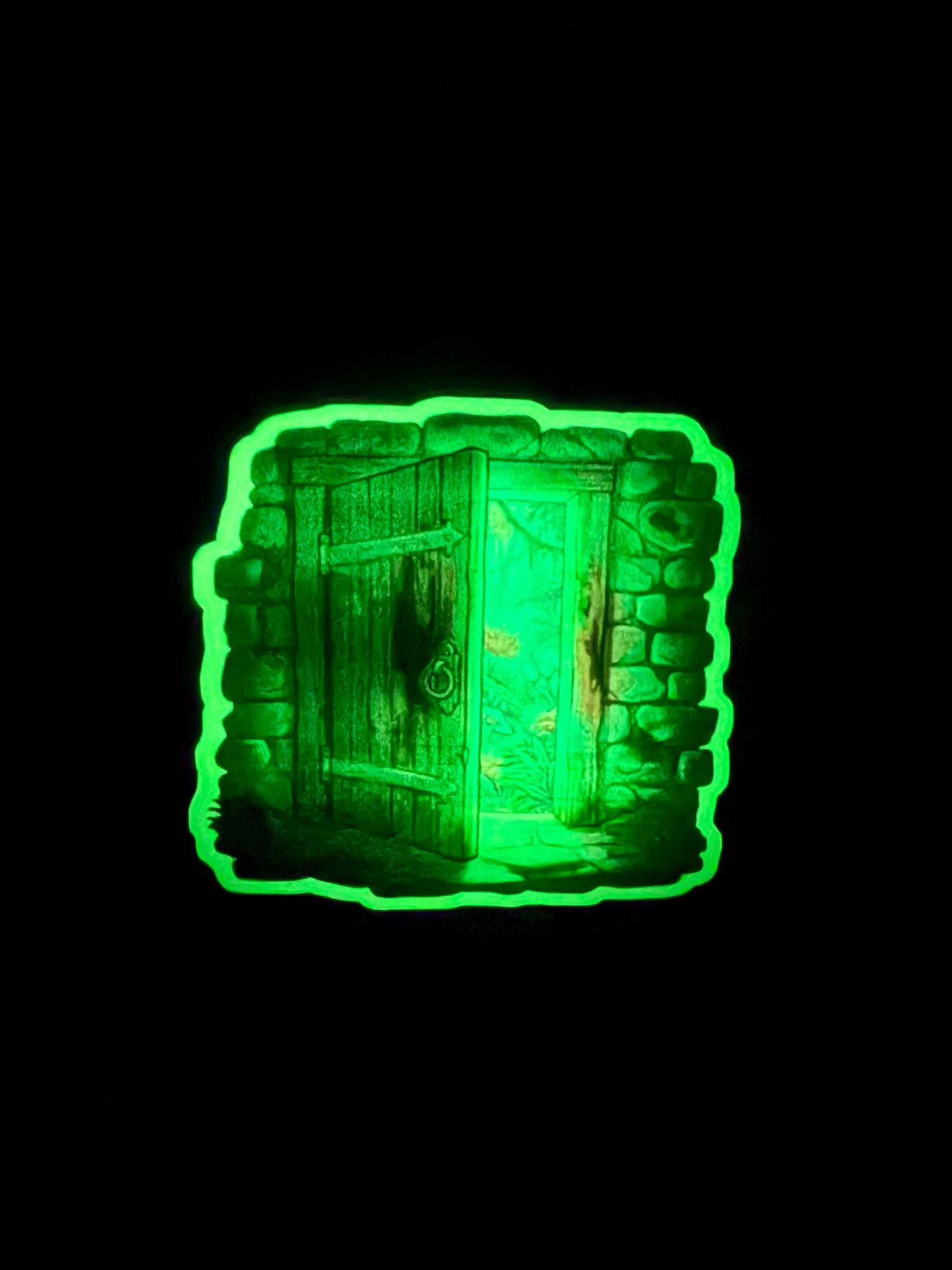 Glowing green decorative item with intricate patterns on a black background