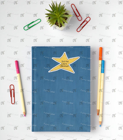 Blue notebook with a yellow star design on a white background with stationery items.