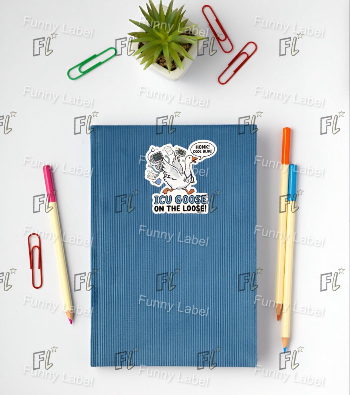 Blue notebook with a cartoon sticker on a white background with stationery items.