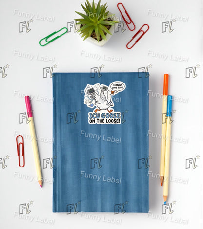 Blue notebook with a cartoon sticker on a white background with stationery items.