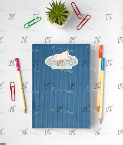 Blue notebook with a sticker, pen, and paper clips on a white background