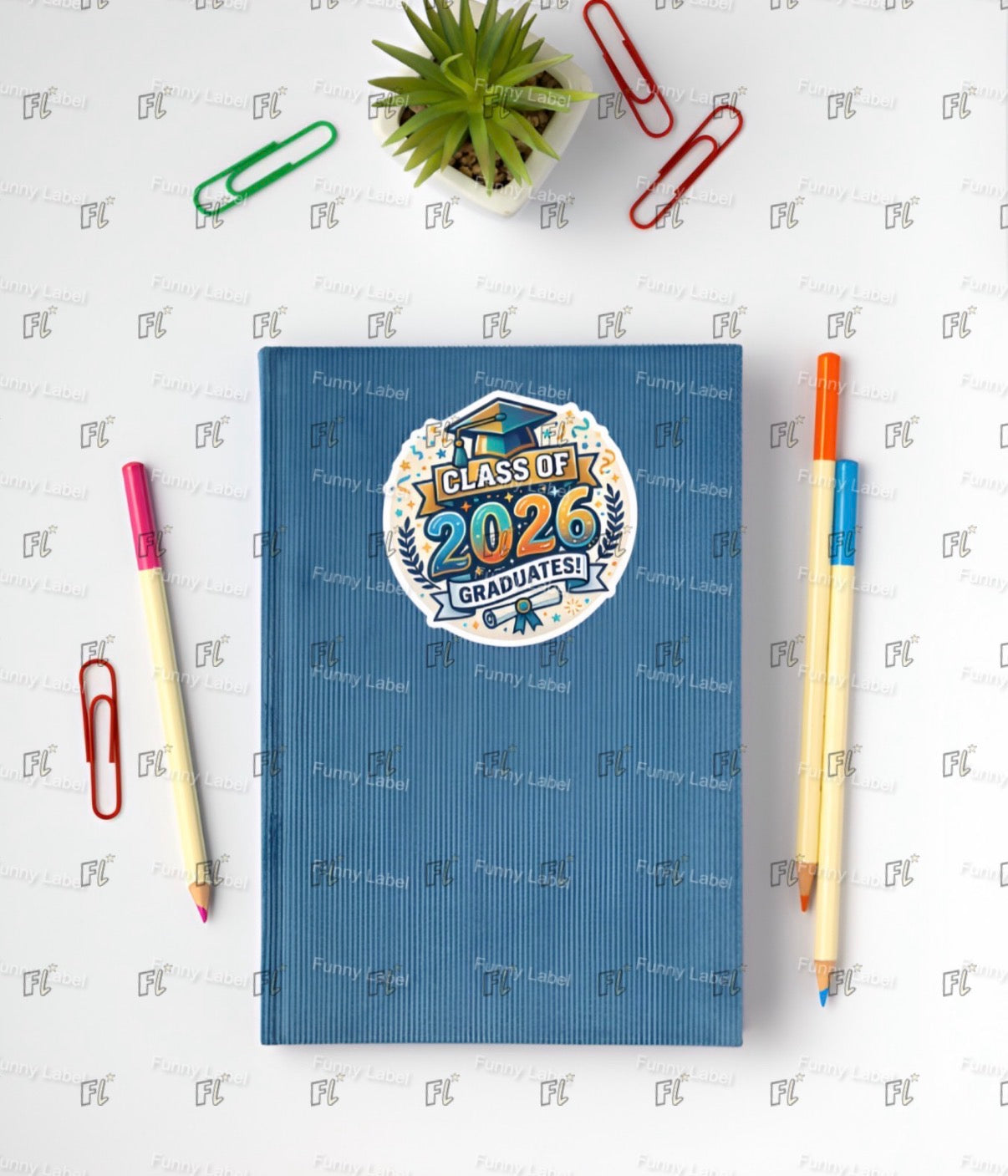 Blue notebook with 'Class of 2026 Graduates!' design on a white background with stationery items.