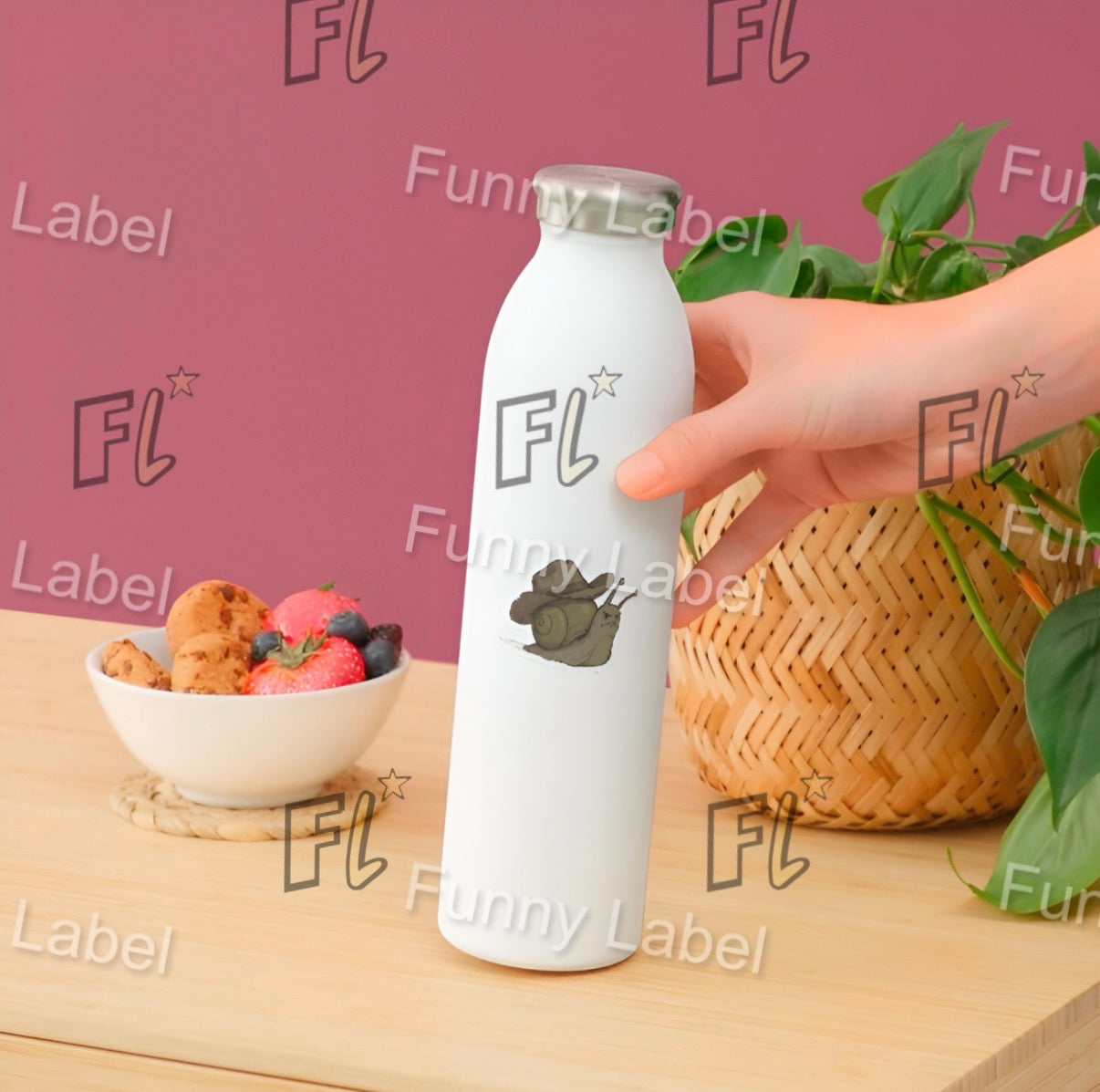 White bottle with 'FL' label held by a hand on a wooden surface with a bowl of fruit and basket in the background.