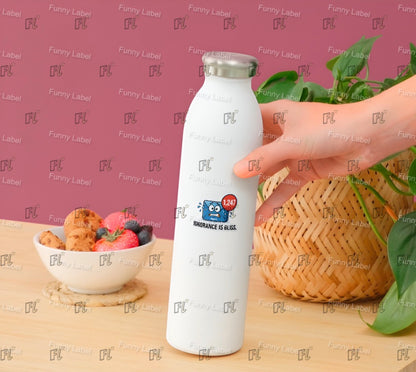 White water bottle with a logo held by a hand on a table with food and plants.