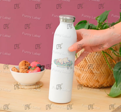 White water bottle with 'FL' branding held by a hand on a wooden surface with a bowl of snacks and a plant.