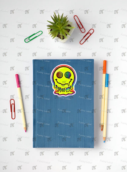 Blue notebook with a colorful sticker on a white surface with stationery items.