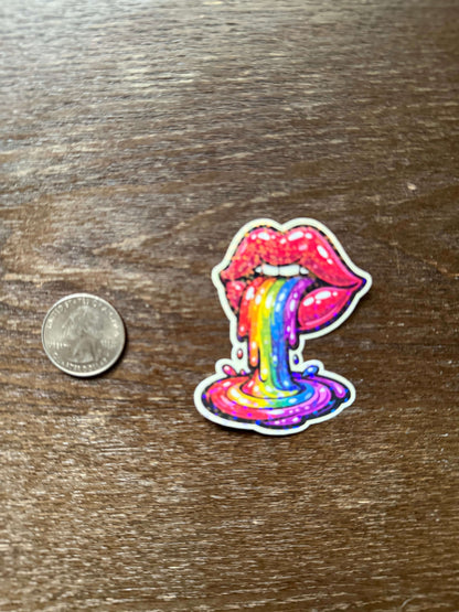 Colorful bow-shaped sticker on a wooden surface with a coin for scale.