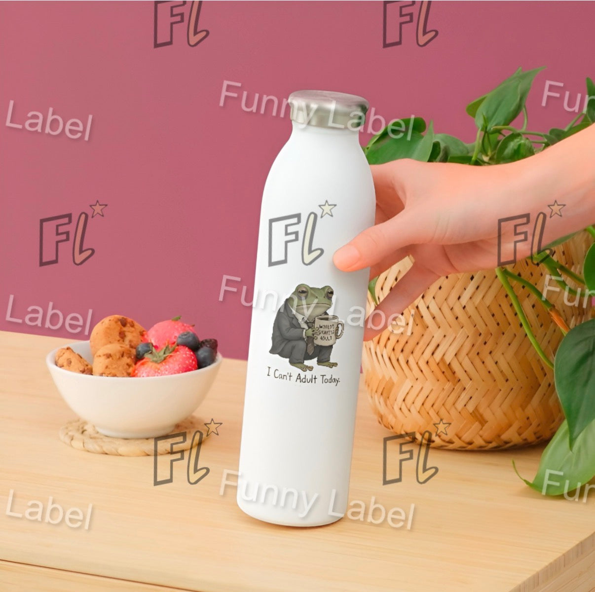 White bottle with 'FL' label held by a hand on a wooden surface with a bowl of fruit and basket in the background.
