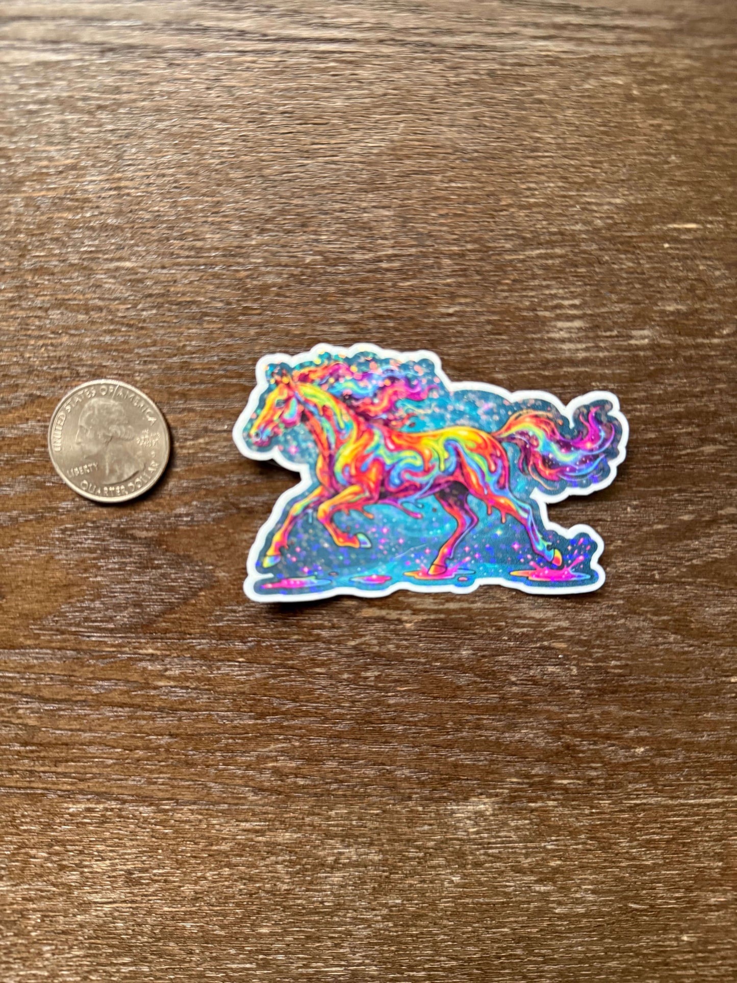 Colorful abstract sticker on a wooden surface with a coin for scale