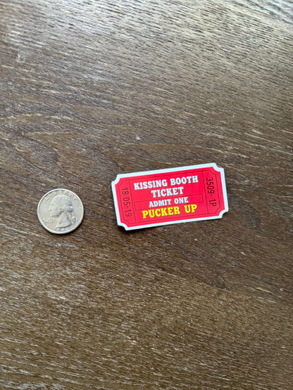 Red and white ticket-like card on a wooden surface with a coin for scale.