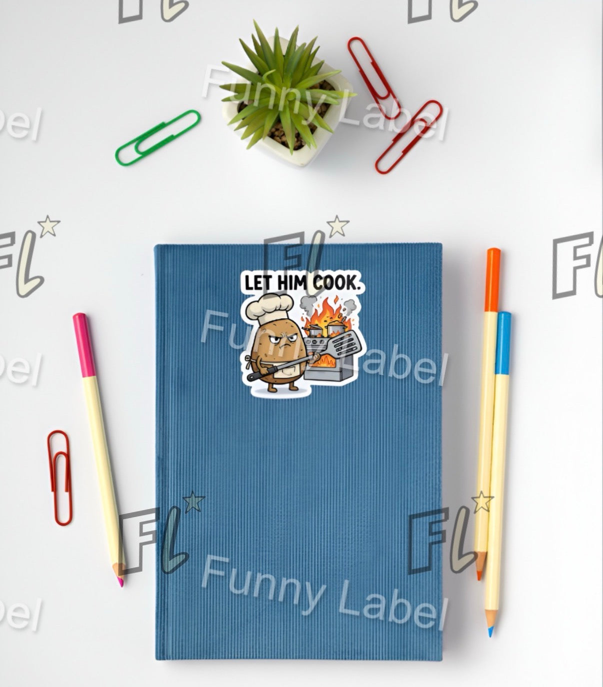 Blue notebook with a sticker on it, surrounded by stationery items on a white background.