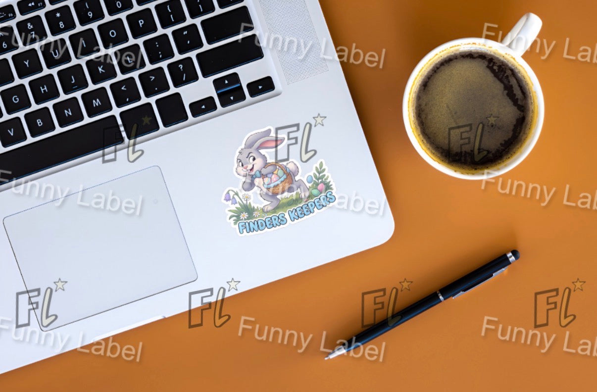 Laptop with a sticker on a desk next to a cup of coffee and pen, with 'Funny Label' branding.