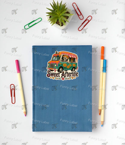 Blue notebook with 'Sweet Afterlife' design on a white background with stationery items.