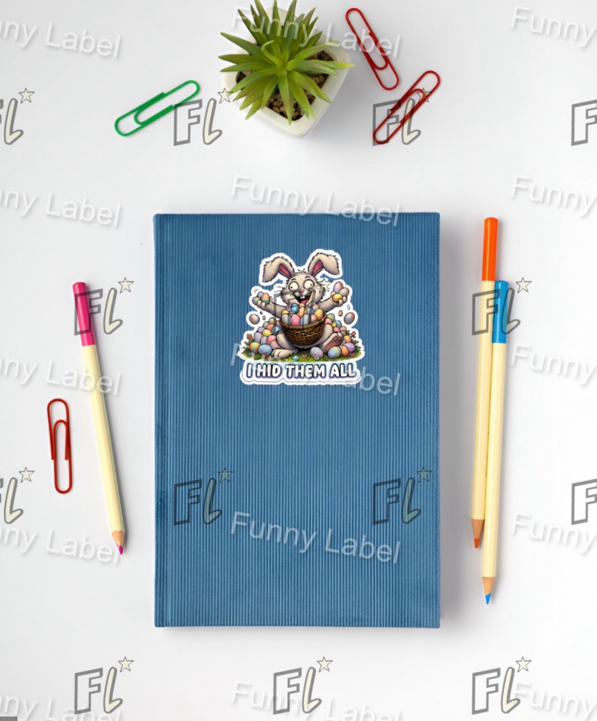 Blue notebook with a sticker on a white background with stationery items.