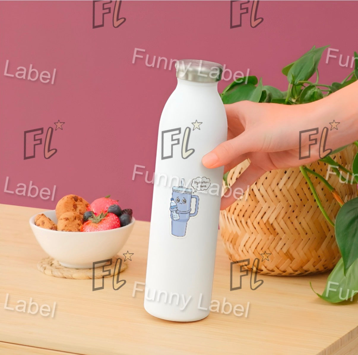 White water bottle with 'FL' label held by a hand on a wooden surface with a bowl of fruit and basket in the background.