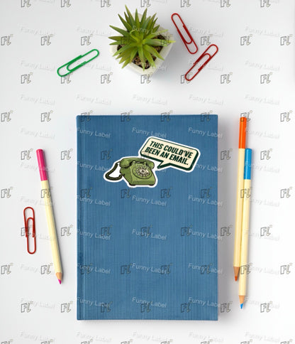 Blue notebook with a sticker on a white surface with stationery items