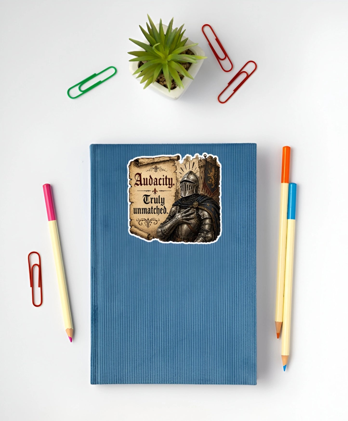 Audacity Truly Unmatched medieval knight sticker displayed on a blue notebook