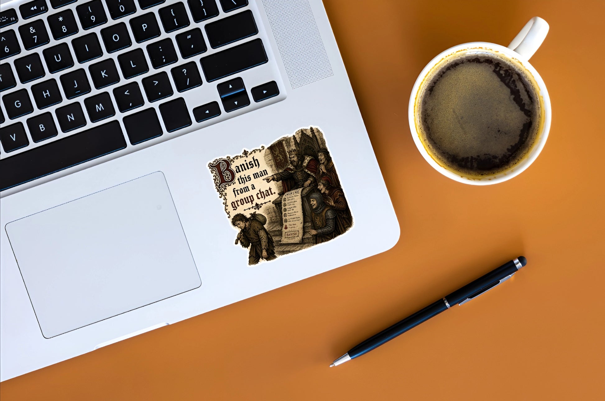 Banish This Man From a Group Chat medieval meme sticker displayed on a silver laptop beside coffee