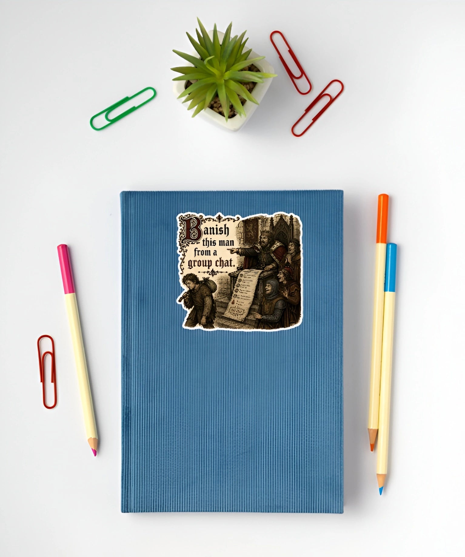 Banish This Man From a Group Chat sticker displayed on a blue notebook