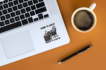 Laptop with a sticker on a desk next to a cup of coffee and pen