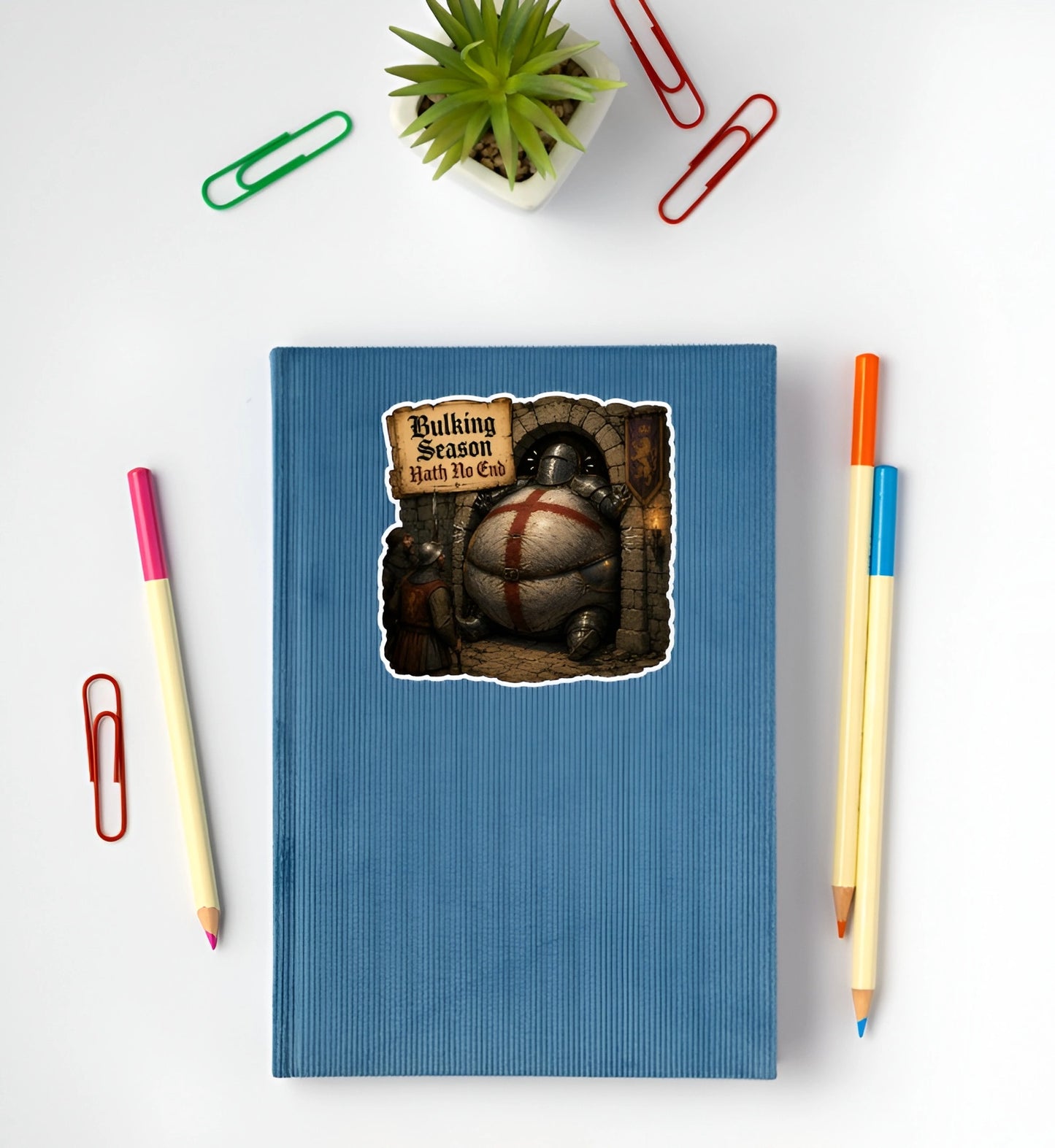 Bulking Season Hath No End medieval knight sticker displayed on a blue notebook featuring an oversized armored knight stuck in a doorway