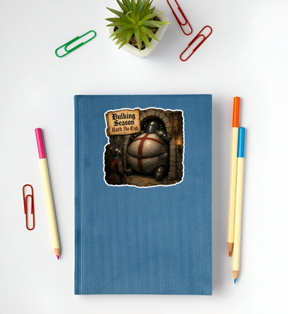 Bulking Season Hath No End medieval knight sticker displayed on a blue notebook featuring an oversized armored knight stuck in a doorway