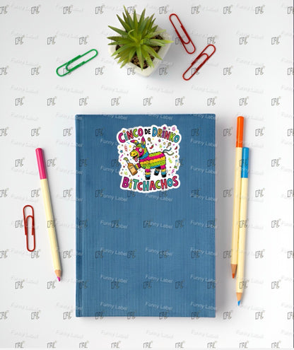 Blue notebook with colorful design on a white background with stationery items.