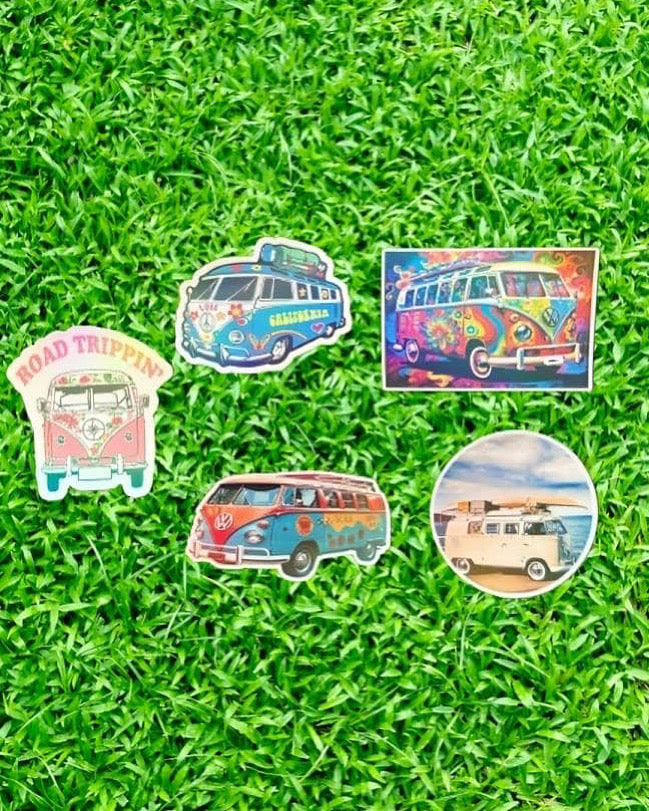 Set of colorful camper van stickers on grass
