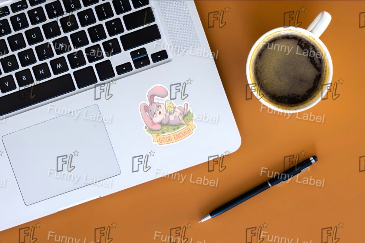Laptop with a sticker on a brown surface with a cup of coffee and pen.