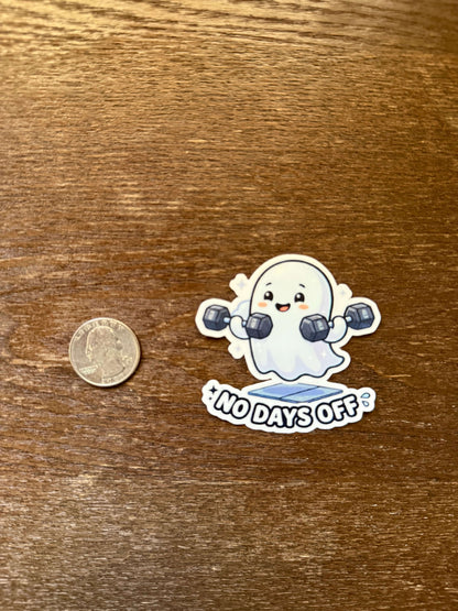 Sticker of a cartoon character with '100 days off' text on a wooden surface with a coin for scale.