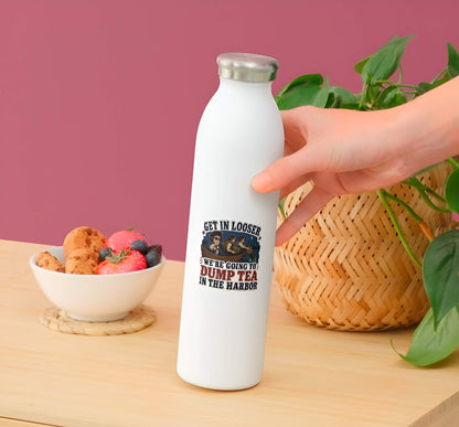 White water bottle with a humorous design held by a hand on a wooden table with snacks and a plant.
