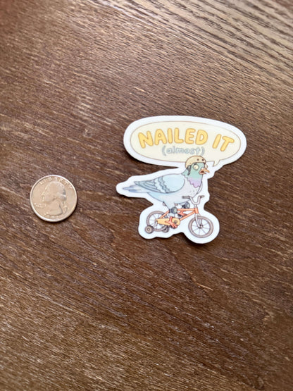 Sticker with 'MAILED IT' text and illustrations on a wooden surface