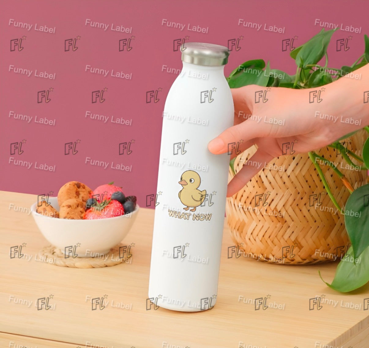 White water bottle with a duck design held by a hand on a wooden surface with a bowl of snacks and a plant.