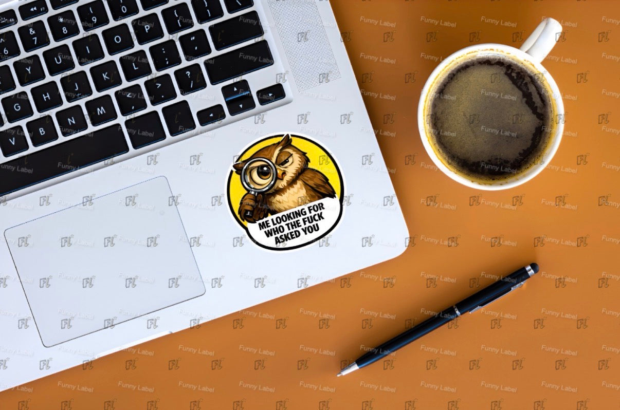 Laptop with a sticker, coffee cup, and pen on a brown surface