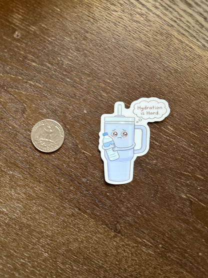 Sticker of a robot with a speech bubble next to a coin on a wooden surface